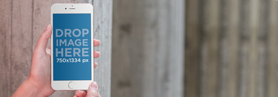 iPhone Mockup Being Held in Front of a Wooden Wall