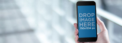 iPhone Mockup Featuring a Woman Texting on a Balcony