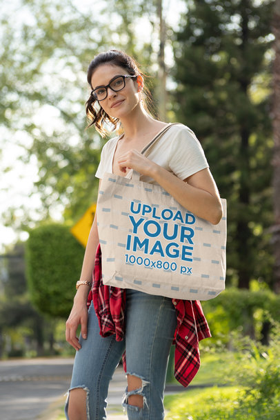 Tote Bag Mockup Featuring a Woman with Glasses Wearing Ripped Jeans 28836