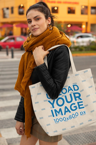 Tote Bag Mockup Featuring a Woman with a Scarf at a Street