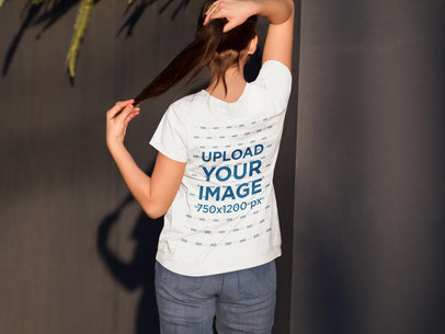 T-Shirt Mockup Featuring a Woman from the Back in a Courtyard
