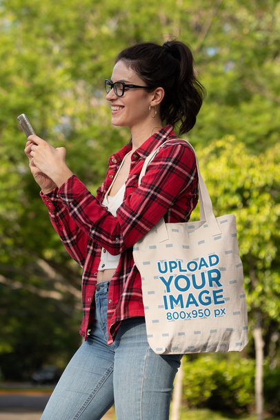 Mockup of a Happy Woman Texting and Carrying a Tote Bag