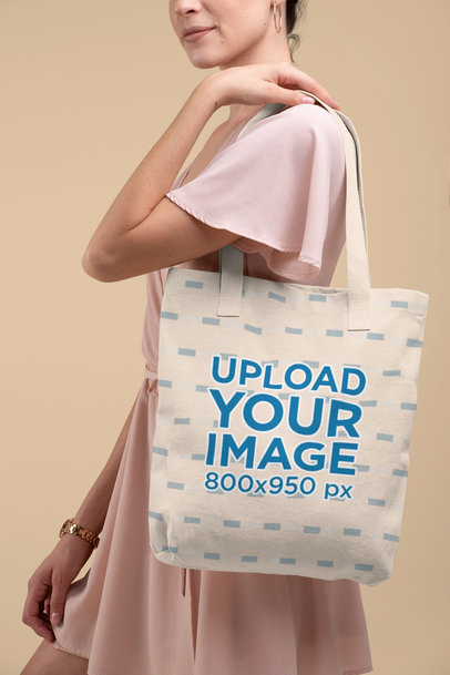 Mockup of a Woman in a Dress Carrying a Tote Bag with a Customizable Strap