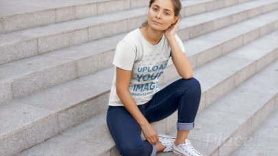 T-Shirt Video of a Smiling Woman Sitting on Concrete Stairs 12889