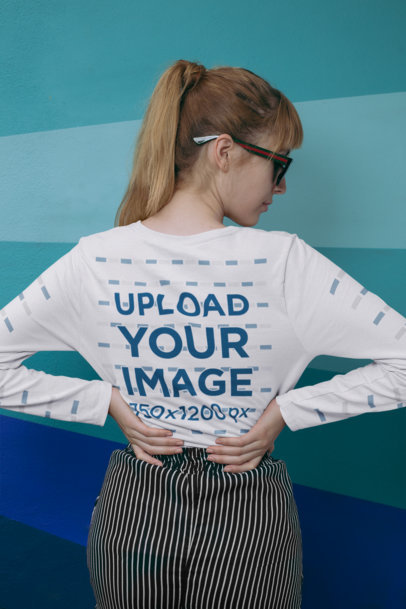 Mockup of a Woman Wearing a Long Sleeve Tee Against a Monochromatic Background