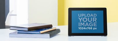 Mockup Template of an iPad Standing on a Table in a Classroom