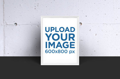 Mockup of a Poster Frame Against a Concrete Wall 