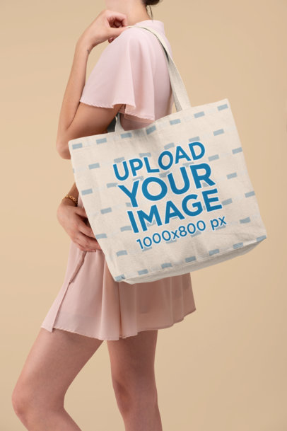 Mockup Featuring a Woman in a Studio Carrying a Tote Bag over Her Shoulder