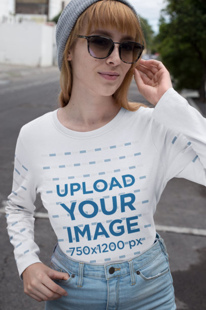 Long Sleeve Tee Mockup of a Woman Wearing a Beanie and Glasses on a Street
