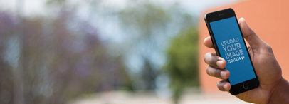 iPhone Mockup Featuring a Black Man Texting a Friend