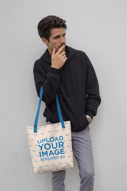 Mockup of a Tote Bag with a Customizable Strap Featuring a Young Man 