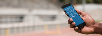 Mockup Template of a Man Using an iPhone at a Running Track