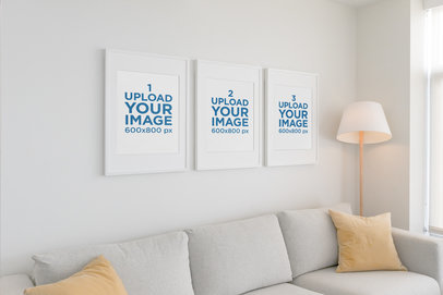 Mockup of Three Poster Frames Hanging on a White Living Room Wall 