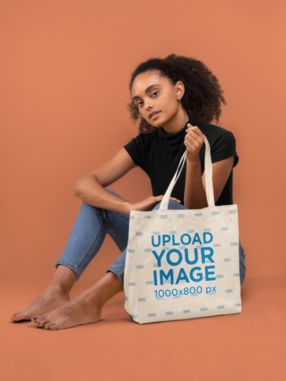 Tote Bag Mockup of a Young Woman Sitting Barefoot 