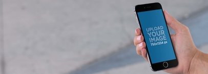 iPhone Mockup of a Guy Standing on a Sidewalk a9759