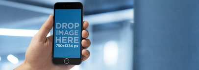 iPhone Mockup of a Man in an Office Using an iPhone