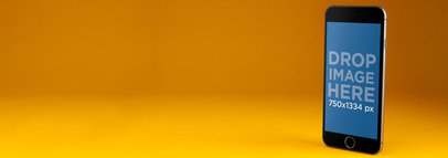 iPhone Mockup Standing Over a Yellow Backdrop 