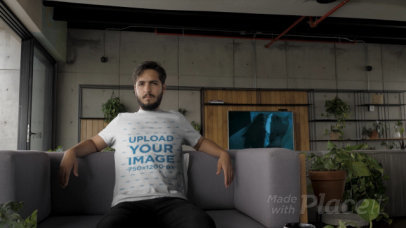 T-Shirt Video of a Man Relaxing on a Gray Couch 28923