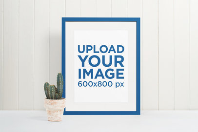 Minimal Mockup Featuring a Picture Frame Standing Next to a Cactus Plant Pot 