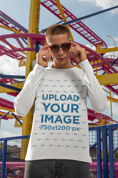Long Sleeve Tee Mockup Featuring a Man with Sunglasses by a Roller Coaster