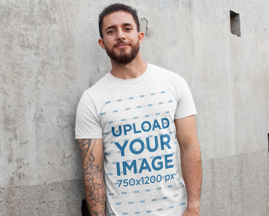 Heathered Tee Mockup of a Man Leaning Against a Concrete Wall 