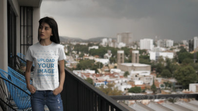 Video of a Woman with a Crewneck T-Shirt Standing in a Balcony 