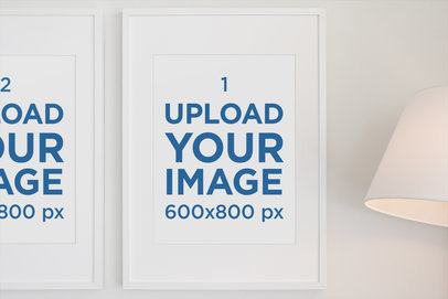 Mockup Featuring Two Art Prints Hanging Next to a Lamp 