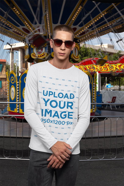 Long Sleeve T-Shirt Mockup of a Man Standing in Front of a Swing Carousel Ride