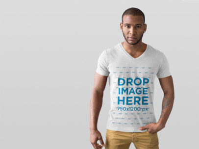 T-Shirt Mockup of a Handsome Man in a Photo Studio