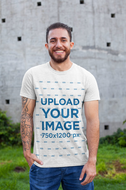 T-Shirt Mockup Featuring a Smiling Man with a Tattooed Arm