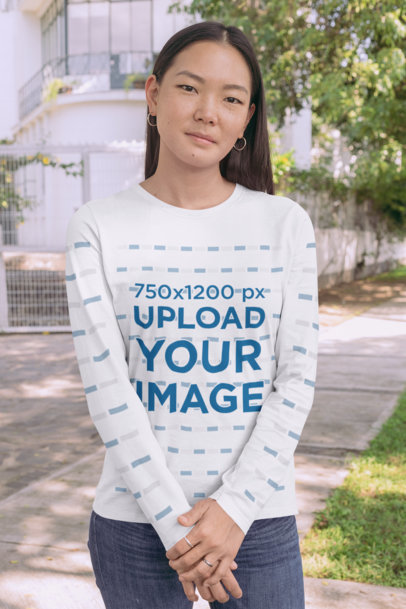 Long Sleeve Tee Mockup Featuring a Young Woman Standing on a Sidewalk 