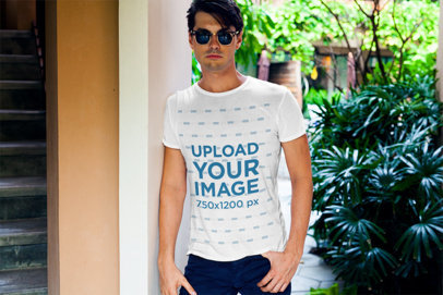 Mockup of a Chic Man Wearing a T-Shirt by Some Plants 