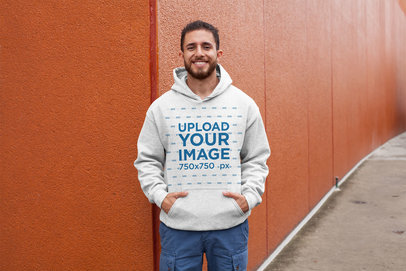 Hoodie Mockup of a Man Posing Against a Red Wall 