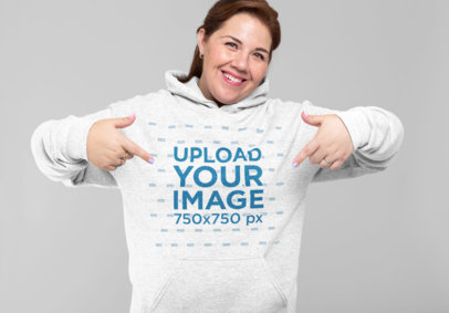 Mockup of a Woman Pointing at Her Heathered Hoodie