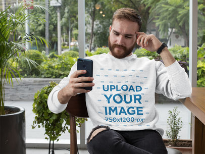 Crewneck Sweatshirt Mockup of a Man Checking His Phone 