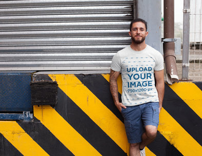 Mockup of a Tattooed Man Wearing a Heather T-Shirt in a Loading Zone