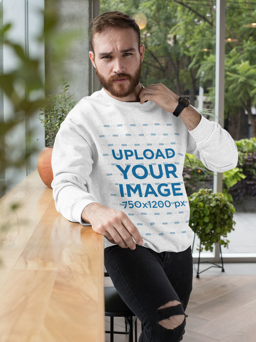 Heather Crewneck Sweatshirt Mockup of a Man Posing by a Wooden Counter