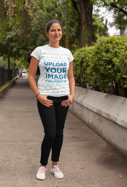 T-Shirt Mockup of a Kind-Looking Woman Posing in a Park Lane 28934