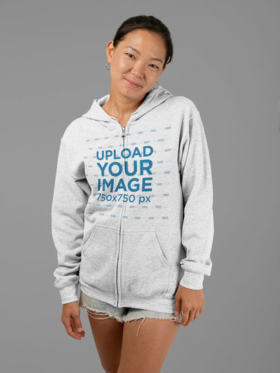 Mockup of a Woman Wearing a Full Zip Heathered Hoodie and Shorts