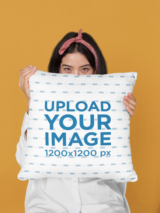 Mockup of a Woman Covering Her Face with a Pillow at a Studio 