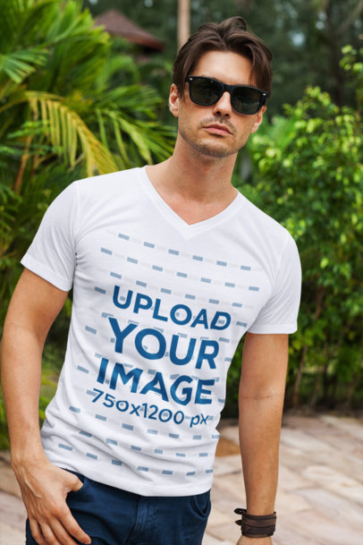 Mockup Featuring a Stylish Man Wearing a V-Neck T-Shirt Against Some Plants
