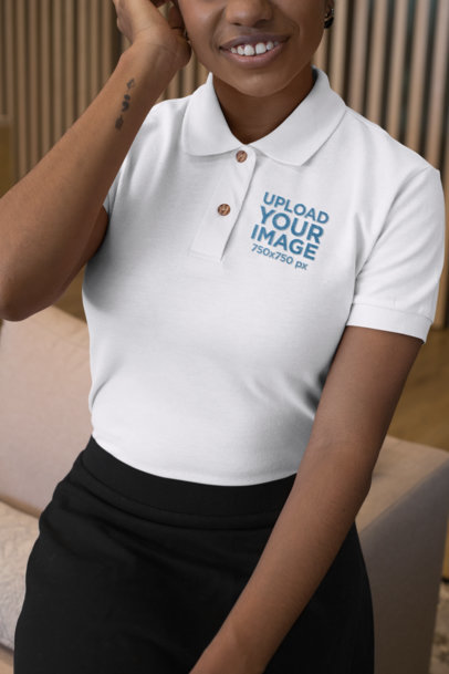 Mockup of a Woman by a Couch Wearing an Embroidered Polo Shirt