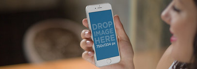 Mockup Template of a Cheerful Woman Using an iPhone