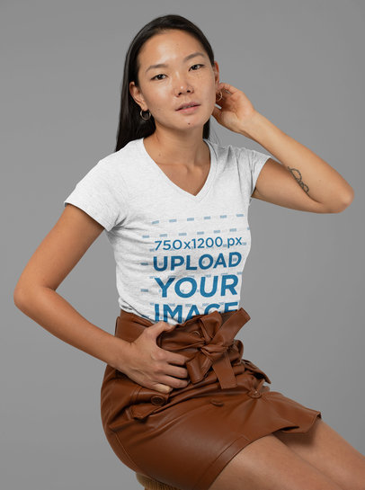 Heather T-Shirt Mockup of a Woman with a Leather Skirt Posing at a Studio 