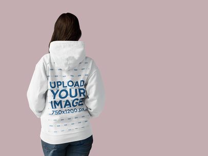 Back Shot of a Woman Wearing a Pullover Hoodie Mockup Facing a Transparent Surface