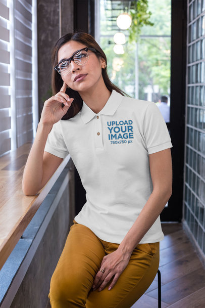 Polo Shirt Mockup of a Woman with Glasses Sitting at a Cafeteria