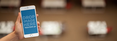 Mockup Template of an iPhone Being Used in a Restaurant