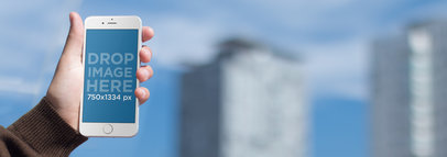 Mockup Template of a Man in a Balcony Using an iPhone