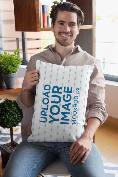 Pillow Mockup of a Man Sitting on a Chair at Home
