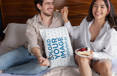 Throw Pillow Mockup Featuring a Couple Eating on a Bed